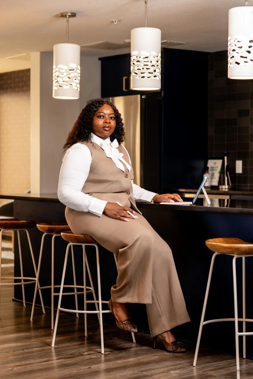Tashie George seated at a counter with her laptop
